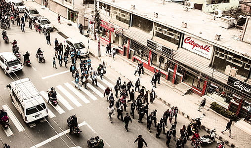 aerial shot of people walking on road beside buildings thumbnail