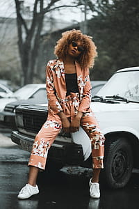 Woman Sitting on White Car Hood thumbnail
