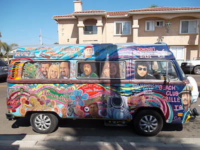 multicolored vehicle parked near building thumbnail