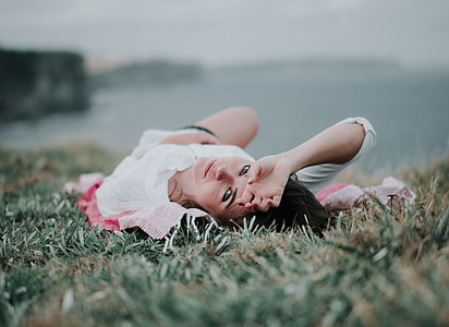 woman lying on green grass thumbnail