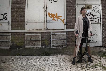 woman wearing gray fringed scarf riding bicycle thumbnail