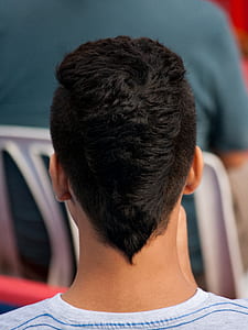 man wearing gray crew-neck shirt near white plastic chair thumbnail