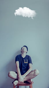 man sitting on brown wooden armless chair wearing black crew-neck t-shirt thumbnail