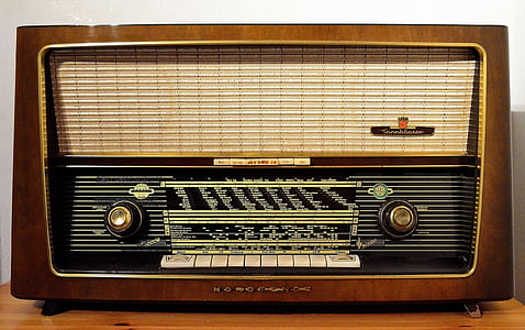 brown and beige transistor radio on brown wooden surface thumbnail