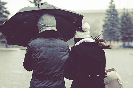 man and woman under black umbrella thumbnail