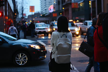 selective photography of woman's back while standing on street thumbnail