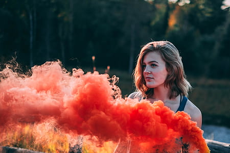 woman in front of orange smokes thumbnail
