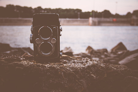 black twin-lens reflex camera on brown rock thumbnail