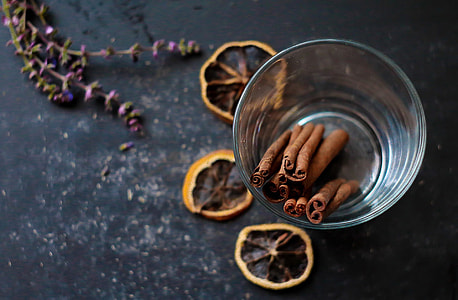focus photo of brown cinnamon sticks in clear drinking glass cup thumbnail