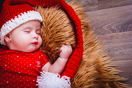 baby wearing red and white knit cap thumbnail