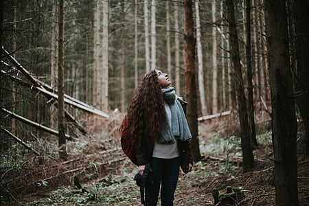 woman standing beside tree thumbnail