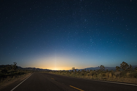 highway in the middle of the desert leaning to mountain ranges thumbnail