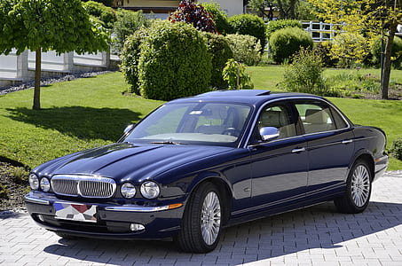 black Jaguar X-Type sedan parked on concrete pathway during daytime thumbnail