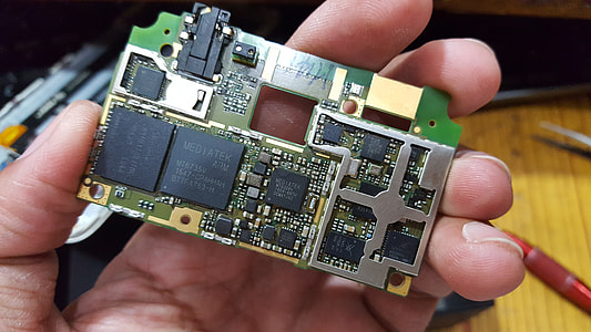 person holding green and black circuit board thumbnail