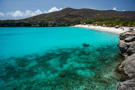 beach near mountain at daytime thumbnail