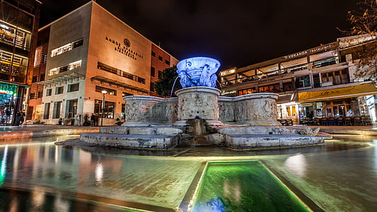 Blue and Gray Water Fountain Near Buildings thumbnail