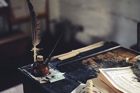 selective focus photography of quill pen and ink thumbnail