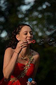 woman in red dress blowing bubbles thumbnail