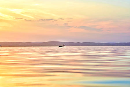 silhouette of person on boat during sunset thumbnail