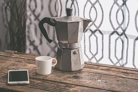 silver Moka pot beside ceramic mug and gold iPhone 7 thumbnail