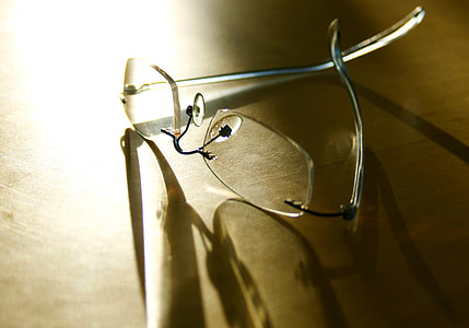 frameless eyeglasses on brown panel thumbnail