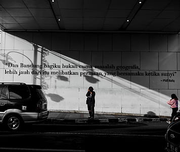 woman standing near SUV on roadside thumbnail