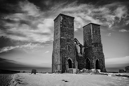An old Saxon pair of towers sit on top of the cliffs at Reculver, Kent, England thumbnail