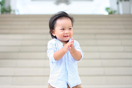 boy smiling while standing near staircase thumbnail