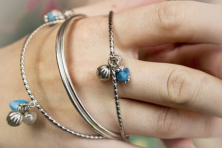 person's silver bangles on wrsit thumbnail