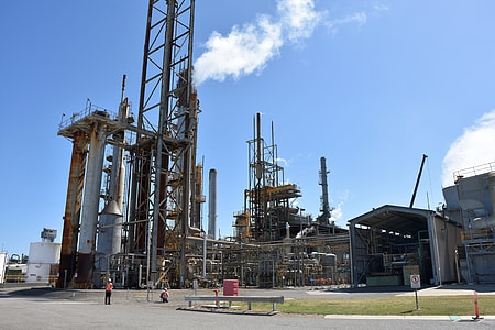 two persons in front of industrial site thumbnail