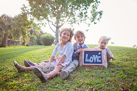 children sitting on grass during dayime thumbnail