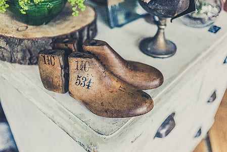 pair of brown shoe last on table thumbnail