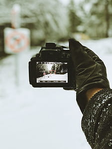 Close-up Photo of Person Holding Black Camera thumbnail