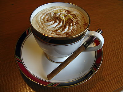 white and black ceramic cup on white and red ceramic saucer thumbnail