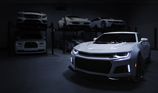 white Chevy Camaro near sports cars thumbnail