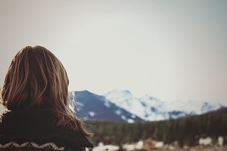 woman wearing black shirt facing green trees and mountains during daytime thumbnail