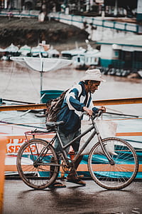 man holding gray bicycle thumbnail