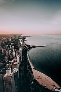 aerial view of city beside body of water thumbnail