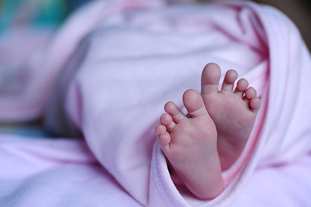 toddler covered with pink blanket thumbnail