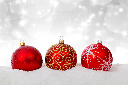 selective color photography of three red glitter baubles on snow surface with lighted background thumbnail