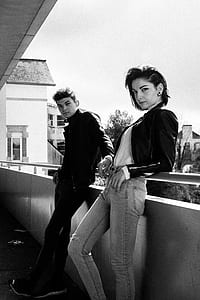 man and woman leaning on railing thumbnail