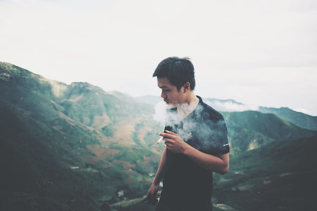 man smoking on mountaintop thumbnail