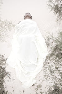 woman lying on ground with white cover thumbnail