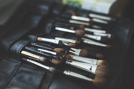 makeup brush in black leather bag thumbnail
