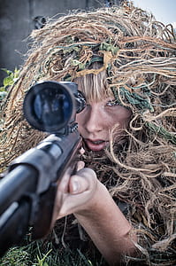 woman in camouflage pointing sniper thumbnail