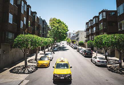 yellow SUV passing on alley during daytime thumbnail