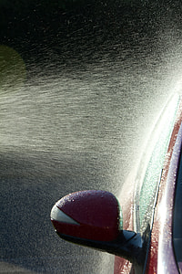 water sprinkled on red vehicle thumbnail