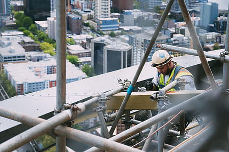 man repairing building during daytime thumbnail