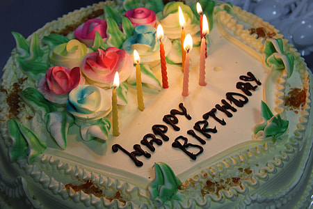 single layer floral themed birthday cake with lighted candles thumbnail