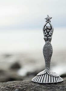 mermaid ceramic figurine on stone thumbnail